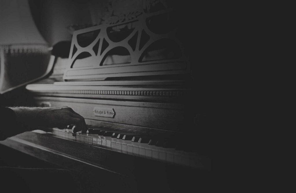 Black and white view of a musician working at a keyboard